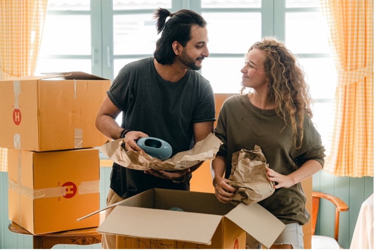 Couple unpacking items in new home