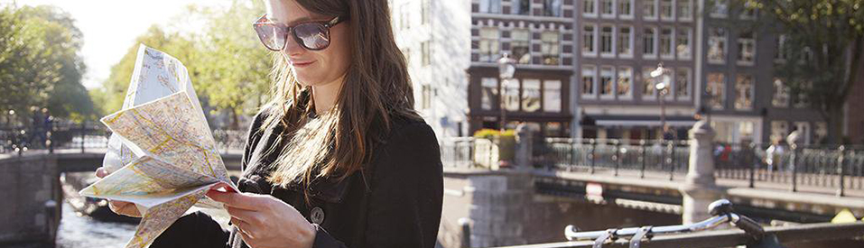 Woman looking at a map, traveling.